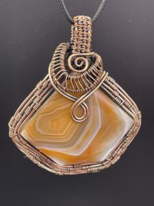Hand Wrapped Copper Wire Solar Agate in Burnt Orange Pendant 1 scaled - Hand Wrapped Copper Wire Solar Agate in Burnt Orange Pendant, 1 - Hand Wrapped Copper Wire Solar Agate in Burnt Orange Pendant, 1 - AURORA ARTISAN JEWELLERY