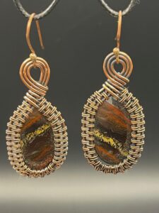Hand-wrapped copper wire earrings featuring iron tiger's eye with striking, layers that blend metallic shimmers with earthy tones.
