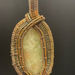 Aqua seraphinite oval cabochon set within an elegant hand-wrapped copper wire pendant.
