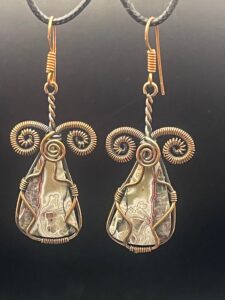 Crazy lace agate with intricate swirling patterns in hand-wrapped copper wire earrings