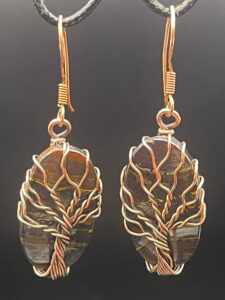 Hand-wrapped copper wire tree of life earrings featuring iron tiger's eye with striking, layers that blend metallic shimmers with earthy tones.