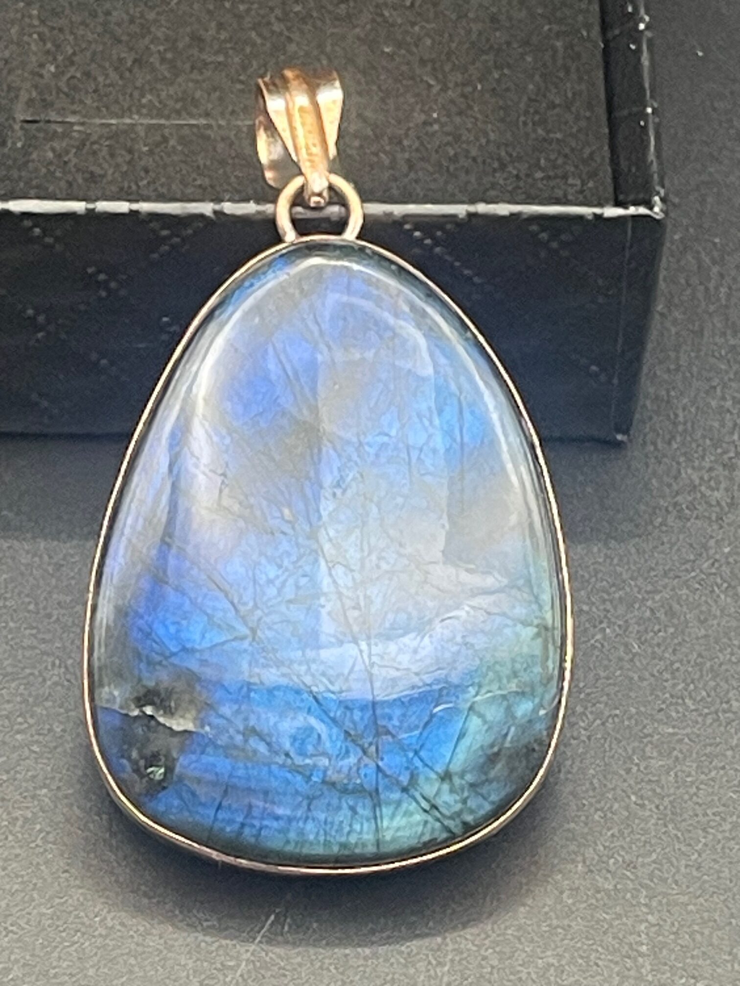 Labradorite in Handmade Pure Copper Pendant 3 Propped on Box rotated - Labradorite in Handmade Pure Copper Pendant, 3 Propped on Box - Labradorite in Handmade Pure Copper Pendant, 3 Propped on Box - AURORA ARTISAN JEWELLERY