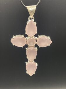 Pretty soft pink rose chalcedony set within an elegant handmade silver plated cross pendant.